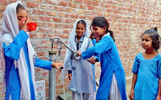 girls students around water tap in school