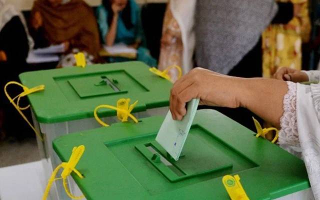 voters throw ballot paper in box