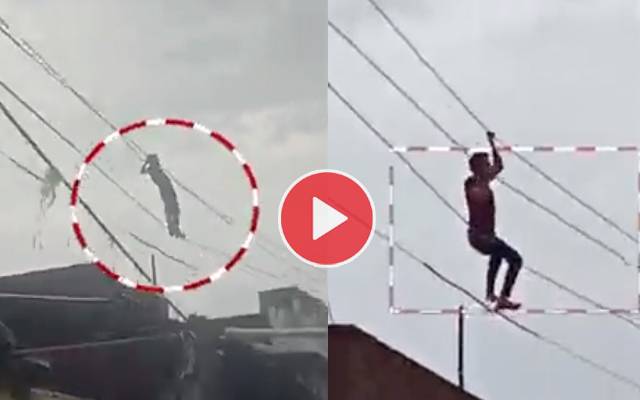 Video of young man swinging on electric wires