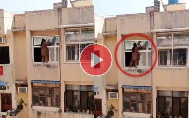 Video of woman cleaning windows while standing on ledge goes viral